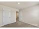 Bedroom featuring neutral walls, carpeted floors, and an open door to an ensuite bathroom at 104 Ciara Pl # B, Mooresville, NC 28117