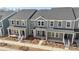 Modern townhomes showcase gray siding, well-manicured landscaping, and inviting entrances for a vibrant community appeal at 104 Ciara Pl # B, Mooresville, NC 28117