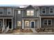 Stylish new construction townhome showcases contemporary design with gray siding, brick accents, and a welcoming front porch at 104 Ciara Pl # B, Mooresville, NC 28117