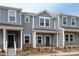 Attractive townhome featuring neutral siding, brick accents, and a welcoming entrance, perfect for comfortable living at 104 Ciara Pl # B, Mooresville, NC 28117