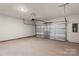 Spacious garage with concrete floor, overhead lighting, and a modern garage door opener at 104 Ciara Pl # B, Mooresville, NC 28117