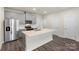 Bright kitchen features stainless steel appliances, a central island and gray cabinets at 104 Ciara Pl # B, Mooresville, NC 28117
