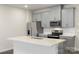 Well-equipped kitchen with stainless steel appliances, quartz countertops, and ample storage at 104 Ciara Pl # B, Mooresville, NC 28117