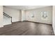 Bright and airy living room featuring a staircase, large windows, and gray flooring at 104 Ciara Pl # B, Mooresville, NC 28117