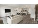 Open floor plan with lots of sunlight featuring modern furnishings and a kitchen with stainless steel appliances at 104 Ciara Pl # B, Mooresville, NC 28117
