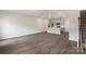 Spacious living area showcasing gray floors leading into the kitchen, great for entertaining at 104 Ciara Pl # B, Mooresville, NC 28117