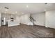 Bright open-concept living room with modern finishes and a staircase at 104 Ciara Pl # B, Mooresville, NC 28117