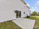 Exterior shot showing a white vinyl siding home with sliding glass door and concrete patio at 1102 Balcorn Pl, Charlotte, NC 28214