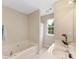 Bathroom featuring a soaking tub with shower and vanity with granite countertops at 1102 Balcorn Pl, Charlotte, NC 28214