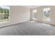 Bedroom with neutral walls, gray carpeting and lots of natural light from the three windows at 1102 Balcorn Pl, Charlotte, NC 28214