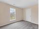 Neutral bedroom showcasing a window for natural light and a complementing light gray carpet at 1102 Balcorn Pl, Charlotte, NC 28214
