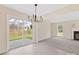 Spacious dining area with tile flooring, backyard access, and modern chandelier at 1102 Balcorn Pl, Charlotte, NC 28214