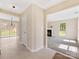 Open entryway with tile flooring leading into a carpeted living area with natural light and backyard view at 1102 Balcorn Pl, Charlotte, NC 28214