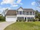 Charming two-story home with black shutters and an attached two-car garage on a well-manicured lawn at 1102 Balcorn Pl, Charlotte, NC 28214