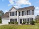 Classic two-story home featuring black shutters, a manicured lawn, and an inviting entrance with tasteful landscaping at 1102 Balcorn Pl, Charlotte, NC 28214