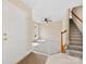 Bright foyer with tiled floor, adjacent carpeted living space, and staircase with wood banister and white risers at 1102 Balcorn Pl, Charlotte, NC 28214