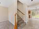 Hallway and Staircase with carpeted steps, wooden handrail, and convenient access to different areas of the home at 1102 Balcorn Pl, Charlotte, NC 28214