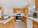 Functional kitchen features wood cabinets, white countertops, tile floors, and stainless steel appliances at 1102 Balcorn Pl, Charlotte, NC 28214