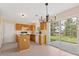 Well-lit kitchen showcases wood cabinetry, island, and sliding doors to a patio and backyard at 1102 Balcorn Pl, Charlotte, NC 28214