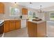 Bright kitchen with island, sliding door to backyard, stainless steel appliances, and natural lighting at 1102 Balcorn Pl, Charlotte, NC 28214