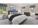 A staged main bedroom with neutral walls, plush gray carpet and updated furnishings at 1102 Balcorn Pl, Charlotte, NC 28214