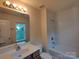 Bright bathroom features a vanity, toilet, and shower-tub combo at 11148 Kanturk Ct, Charlotte, NC 28213