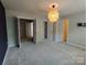 Bedroom features neutral walls, carpet, and unique light fixture at 11148 Kanturk Ct, Charlotte, NC 28213
