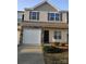 Charming two-story home featuring a one car garage, stone accents, and a welcoming dark front door at 11148 Kanturk Ct, Charlotte, NC 28213