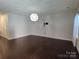 Spacious living room featuring hardwood floors and a modern light fixture at 11148 Kanturk Ct, Charlotte, NC 28213
