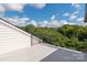 Spacious balcony with black railing offering panoramic view of the tree-lined neighborhood at 1119 N Myers St, Charlotte, NC 28206