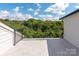 Balcony offers serene view of wooded area and houses, with sturdy black metal railing at 1119 N Myers St, Charlotte, NC 28206