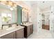 Dual vanities bathroom with unique wall paper, elegant lighting, and modern fixtures at 1119 N Myers St, Charlotte, NC 28206