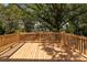 Large wooden deck offers a perfect spot for outdoor gatherings surrounded by lush greenery and shade at 1119 N Myers St, Charlotte, NC 28206