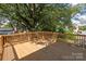 Spacious wooden deck surrounded by mature trees offers a private and serene outdoor living space at 1119 N Myers St, Charlotte, NC 28206