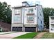 The home showcases a modern design with stone accents, a rooftop terrace, and a two-car garage at 1119 N Myers St, Charlotte, NC 28206