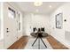 Bright foyer with bench seating, black accent table, and hardwood floors at 1119 N Myers St, Charlotte, NC 28206