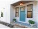Inviting entryway with a teal front door, black trim, and potted plants creates a welcoming first impression at 1119 N Myers St, Charlotte, NC 28206