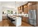Beautiful kitchen features a large island with seating, stainless steel appliances, and wood cabinets at 1119 N Myers St, Charlotte, NC 28206