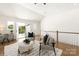 Bright living room with two chairs, white rug, and access to outdoor deck at 1119 N Myers St, Charlotte, NC 28206