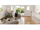 Inviting living area with hardwood floors, French doors to balcony, and desk area with neutral finishes at 1119 N Myers St, Charlotte, NC 28206