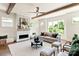 Bright living room boasts hardwood floors, a modern fireplace, and abundant natural light from large windows at 1119 N Myers St, Charlotte, NC 28206
