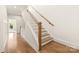 Inviting foyer with a staircase featuring hardwood steps and white painted risers at 1119 N Myers St, Charlotte, NC 28206