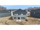Back exterior view of the two-story home, featuring a yard and an AC unit at 117 Obadiah Ct, Troutman, NC 28115