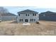 Back exterior view of the two-story home, featuring a yard and an AC unit at 117 Obadiah Ct, Troutman, NC 28115