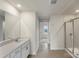 Bright bathroom featuring a vanity, mirror, tile floors, and a tiled shower at 117 Obadiah Ct, Troutman, NC 28115