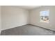 Well-lit bedroom with neutral walls, carpet, and a window offering neighborhood views at 117 Obadiah Ct, Troutman, NC 28115