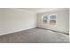 Cozy carpeted bedroom with two windows offering natural light at 117 Obadiah Ct, Troutman, NC 28115