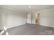 A well-lit, carpeted bedroom with neutral paint and simple trim at 117 Obadiah Ct, Troutman, NC 28115