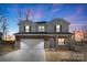 Charming two-story home with a brick and siding exterior, a two-car garage, and a well-maintained lawn at 117 Obadiah Ct, Troutman, NC 28115
