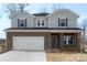 Attractive two-story home with a brick and siding facade, an attached two-car garage, and a clean, inviting appearance at 117 Obadiah Ct, Troutman, NC 28115
